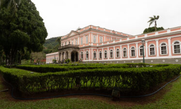 Front view of the Imperial Museum in Petrópolis, Rio de Janeiro, Brazil, showcasing its neoclassical architecture and lush gardens of the former imperial palace.